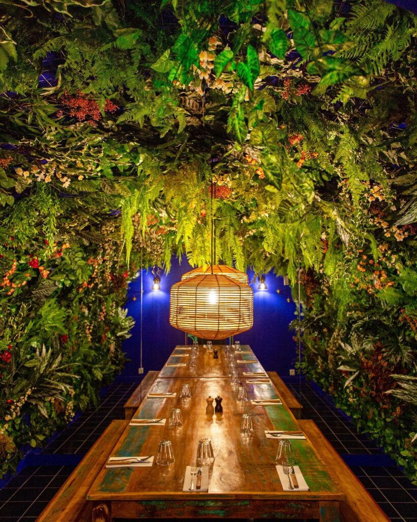 Les Naturistes transformed a Pizza & Pasta place in Paris into a unique eatery surrounded with abundant greenery